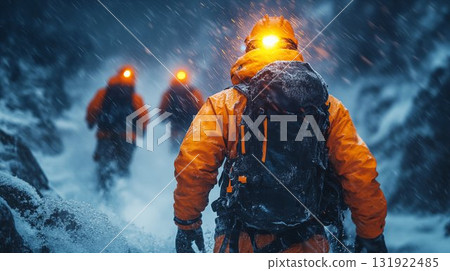 Mountain climbers traversing snowy terrain in severe winter storm. Extreme adventure expedition with professional equipment and safety gear 131922485