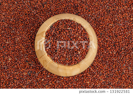 red quinoa seeds in wooden bowl as a background. Top view. Flat lay red quinoa seeds in wooden bowl as a background. Top view. Flat lay 131922581