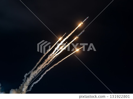 Rockets launching into the night sky, showcasing powerful propulsion and dynamic visual electric din 131922801