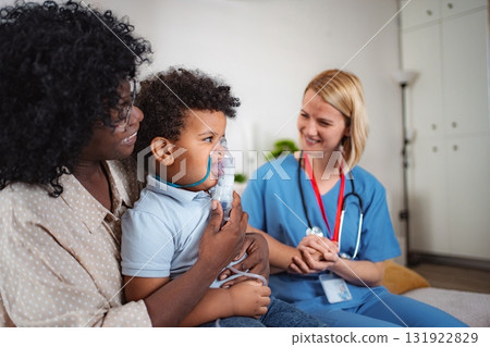 Pediatrician examining young patient at home 131922829