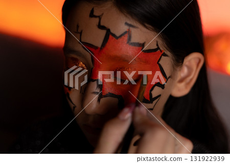 a makeup artist applies makeup to a girl for Halloween party a makeup artist applies makeup to a girl for Halloween party 131922939