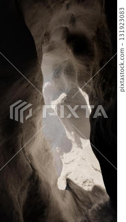 3D rendering. Light at the end of the tunnel through the rock. A cave in the mountain with an exit at the end. 3D rendering. Light at the end of the tunnel through the rock. A cave in the mountain with an exit at the end. 131923083