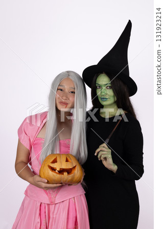 women as witches holding pumpkins.. 131923214