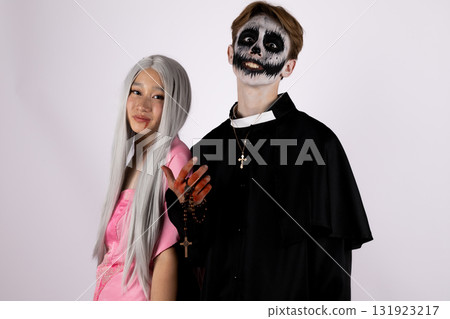Man and woman in skeleton costumes dancing joyfully at Halloween party, 131923217