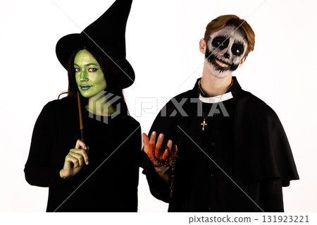 A witch and a person in a skeleton costume are celebrating Halloween A witch and a person in a skeleton costume are celebrating Halloween 131923221