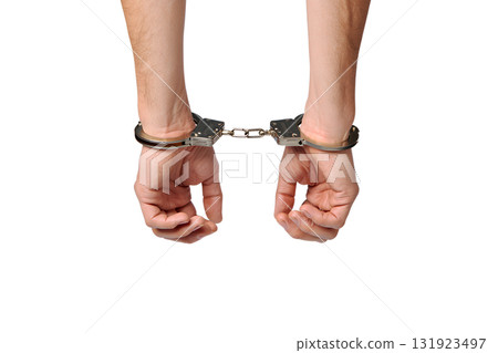 Person's hands bound in cold, hard handcuffs, isolated on transparent background for legal, crime, or protest concepts 131923497