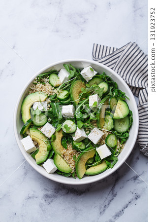 Green quinoa salad with cucumber, avocado and feta. 131923752