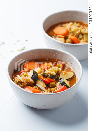 Vegetarian bean tomato soup with vegetables on white background. Vegetarian bean tomato soup with vegetables on white background. 131923764