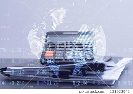 Calculator with holographic world map and financial data overlay on office desk. Global business finance concept showing international trading, economic analysis, and worldwide market connections. Calculator with holographic world map and financial data overlay on office desk. Global business finance concept showing international trading, economic analysis, and worldwide market connections. 131923941