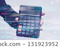 Hand holding a calculator displaying 2025 against a background of financial data and stock market charts. Concept economic forecasts and business predictions for the year 2025. 131923952