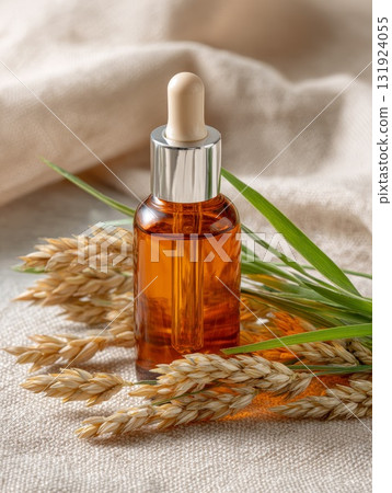 Sea buckthorn oil in amber cosmetic bottle with natural elements and soft fabric background 131924055