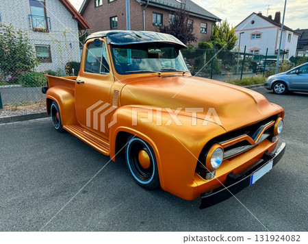 Vintage truck shines bright under the sunset, showcasing creativity and craftsmanship in a charming neighborhood setting Vintage truck shines bright under the sunset, showcasing creativity and craftsmanship in a charming neighborhood setting 131924082