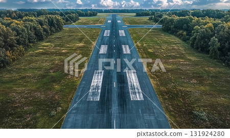 Aerial View of an Isolated Airfield Runway Featuring Precise Markings for Enhanced Aircraft Safety Aerial View of an Isolated Airfield Runway Featuring Precise Markings for Enhanced Aircraft Safety 131924280