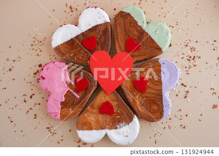 Flat lay greeting card Valentine's Day Delicious fresh variety croissants topped with colorful flavor Ganache. Creation unique heart shape bakery. Puff pastry holiday love gift present idea Flat lay greeting card Valentine's Day Delicious fresh variety croissants topped with colorful flavor Ganache. Creation unique heart shape bakery. Puff pastry holiday love gift present idea 131924944