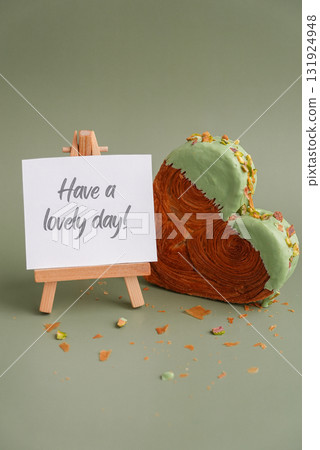 HAVE A LOVELY DAY saying text greeting card Delightful and vibrant heartshaped pastry croissant treat, beautifully topped with colorful frosting nut galore. Mock up template copy space. Food HAVE A LOVELY DAY saying text greeting card Delightful and vibrant heartshaped pastry croissant treat, beautifully topped with colorful frosting nut galore. Mock up template copy space. Food 131924948