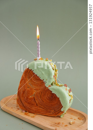 Festive burning candle birthday celebration Delicious fresh croissant topped with Matcha Green Tea flavor Ganache. Creation unique heart shape bakery. Puff pastry holiday love gift present idea Festive burning candle birthday celebration Delicious fresh croissant topped with Matcha Green Tea flavor Ganache. Creation unique heart shape bakery. Puff pastry holiday love gift present idea 131924957