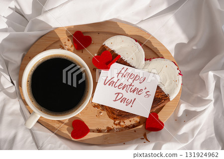 Flat lay top view HAPPY VALENTINE'S DAY phrase lettering paper greeting card Morning breakfast in bed in wooden tray Present gift idea Holiday celebration Heart shaped croissants. Puff pastry new Flat lay top view HAPPY VALENTINE'S DAY phrase lettering paper greeting card Morning breakfast in bed in wooden tray Present gift idea Holiday celebration Heart shaped croissants. Puff pastry new 131924962