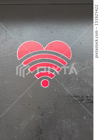 Heart symbol with Wi-Fi signal waves in red color on a dark background, representing connectivity and love in a modern digital age, ideal for technology and relationship themes 131925422