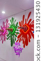 Colorful wall art featuring vibrant paint splashes in green, pink, and red, with illuminated ice cream cones and a playful neon sign conveying a cheerful message 131925430