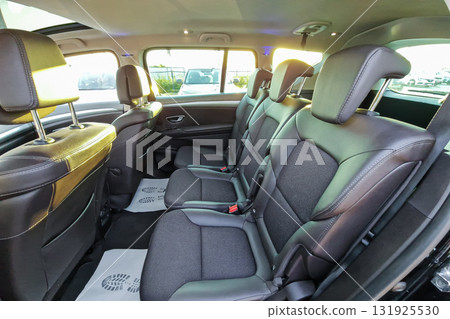 Spacious interior of a modern vehicle with comfortable seating and ample legroom during daylight hours 131925530