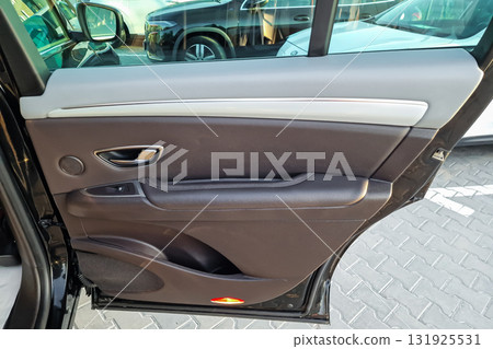 Car door interior design showcasing quality materials and modern features found in a parked vehicle in a parking lot Car door interior design showcasing quality materials and modern features found in a parked vehicle in a parking lot 131925531
