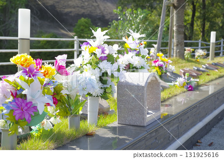 A cemetery surrounded by greenery 131925616