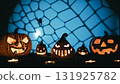 Halloween pumpkins lined up in silhouette in front of a scary background 131925782