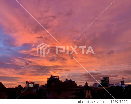 A vibrant sunset over Phnom Penh, Cambodia: A fantastical landscape where the city and nature coexist in harmony 131925921