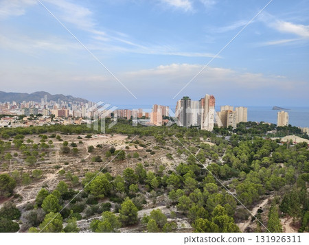 Experience the Stunning Aerial View of Benidorms Beautiful Green Hills and Iconic Coastal Skyline 131926311