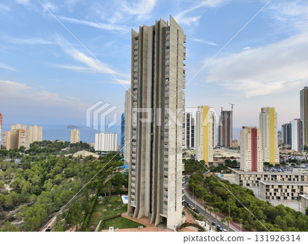 A modern skyscraper stands in a vibrant urban landscape, showcasing architectural brilliance A modern skyscraper stands in a vibrant urban landscape, showcasing architectural brilliance 131926314
