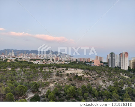 A Stunning Cityscape at Dusk with Lush Greenery, showcasing breathtaking visuals in evening light A Stunning Cityscape at Dusk with Lush Greenery, showcasing breathtaking visuals in evening light 131926318