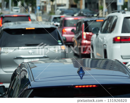 A line of cars driving through the streets of Nagoya on a summer afternoon A line of cars driving through the streets of Nagoya on a summer afternoon 131926820