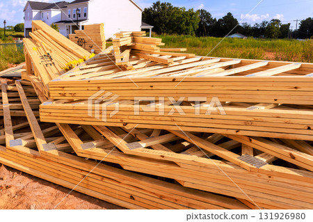 Stacked wooden beams roofing joint construction materials sit at building site under frame time 131926980