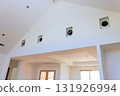 Bright living space features high ceilings, recessed vent openings, large windows during build new home 131926994
