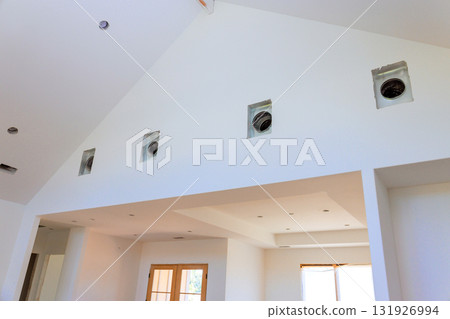 Bright living space features high ceilings, recessed vent openings, large windows during build new home 131926994