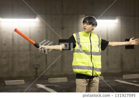 Young staff directing cars Young staff directing cars 131927095