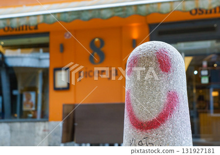 A parking barrier graffitied with red paint A parking barrier graffitied with red paint 131927181