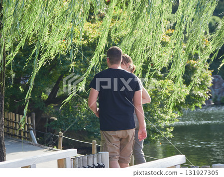 A young couple of foreign tourists taking a walk in Tokugawa Garden in summer A young couple of foreign tourists taking a walk in Tokugawa Garden in summer 131927305