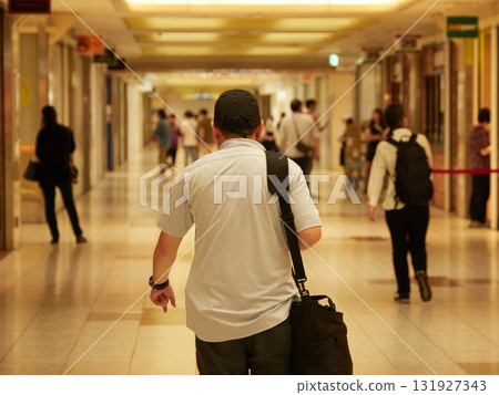Male office worker and commuters and tourists walking in the underground shopping mall in Nagoya 131927343