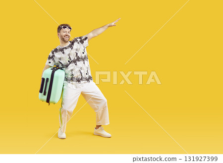 Funny young man in sunglasses with suitcase is going on summer holiday on yellow background. 131927399