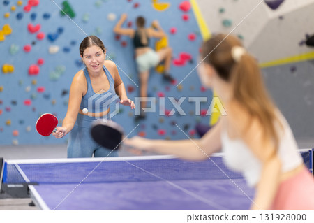 Two women play table tennis with passion 131928000