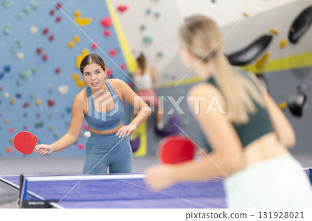 Two women play table tennis with passion Two women play table tennis with passion 131928021