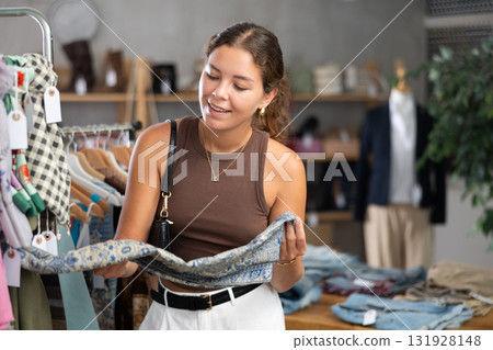 woman chooses a scarf and a handkerchief around her neck 131928148