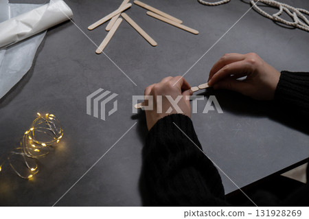 Ice cream sticks Christmas tree Sustainable preparation Diy process making handmade decoration. Step by step activity for children. Inclusive and responsible stress relief holiday hobby 131928269