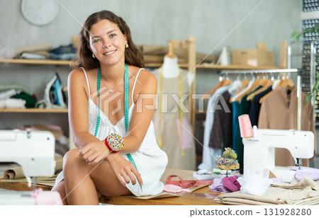 dressmaker playfully poses in the workshop 131928280