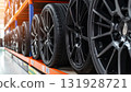 A lot of car rims on the shelf for sale 131928721