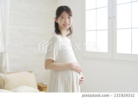Pregnant woman portrait at home looking at camera Pregnant woman portrait at home looking at camera 131929332