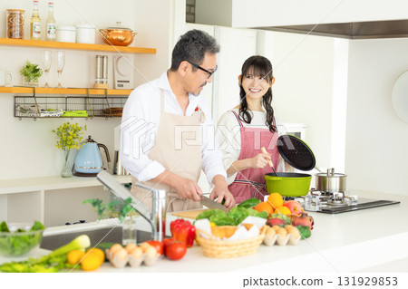 Kitchen: Middle-aged couple cooking Kitchen: Middle-aged couple cooking 131929853