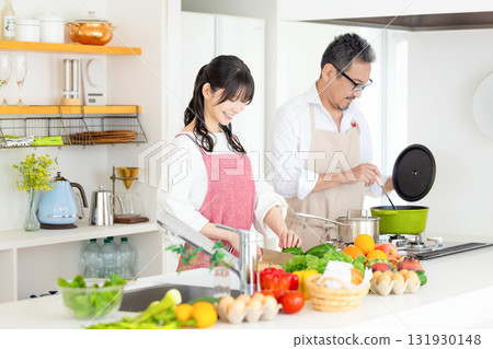 Kitchen: Middle-aged couple cooking Kitchen: Middle-aged couple cooking 131930148