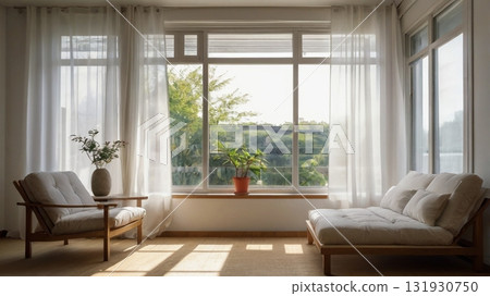 A female college student enjoys reading in the gentle breeze in a white-themed room. A female college student enjoys reading in the gentle breeze in a white-themed room. 131930750
